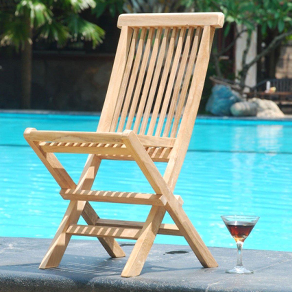 Indonesian teak folding garden chair displayed beside a swimming pool